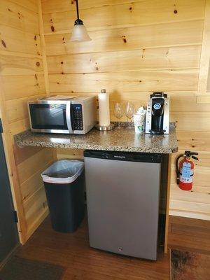 Upper & Lakeview Singles have a mini-refrigerator, microwave, & Keurig Coffee maker within the living room space.