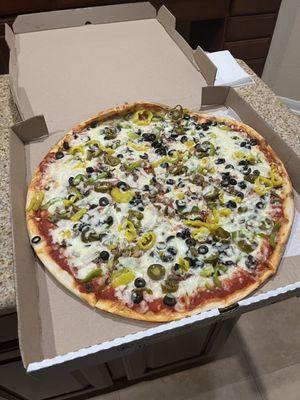 Vegetable pizza with added jalapeños and bell peppers