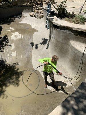 Power washing pool to prepare for acid wash