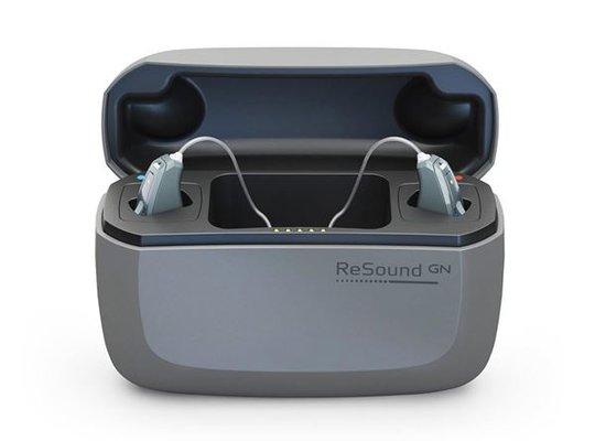 Charging station for rechargeable hearing aids