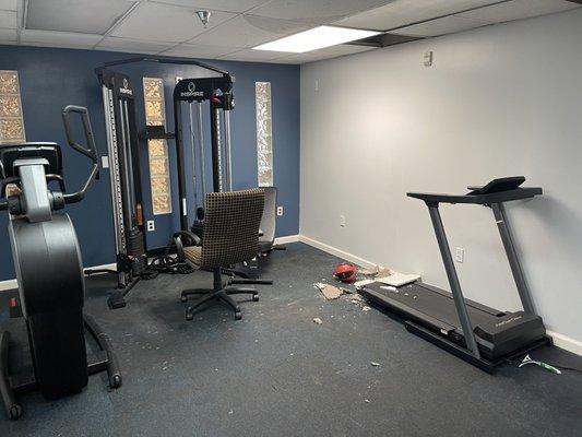 Fitness room with damaged ceiling.