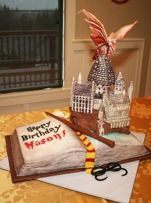 harry potter themed birthday cake with chocolate castle and sugar dragon