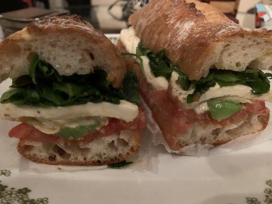 Mozzarella, tomato, arugula, avocado on a baguette