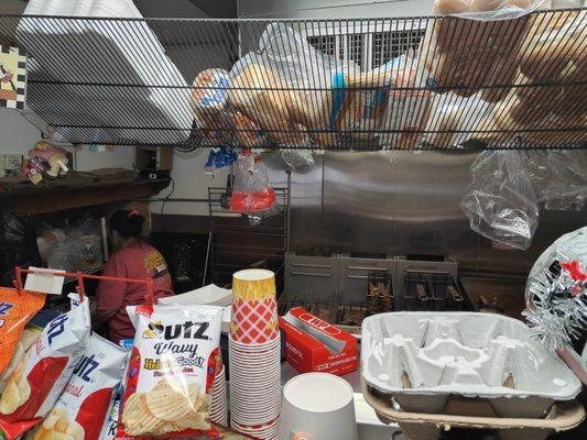 Where the magic happens -- you can see the potato press that chops the potatoes fresh just to the right of the lady