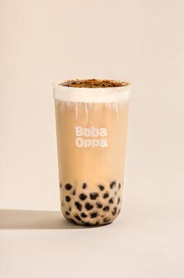 Signature Milk Tea. Black tea mixed with a non-dairy cream, brown sugar brulee top, and finished off with our handcrafted brown sugar boba.