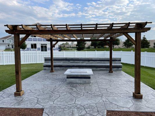 Stamped patio with seating wall and a pergola