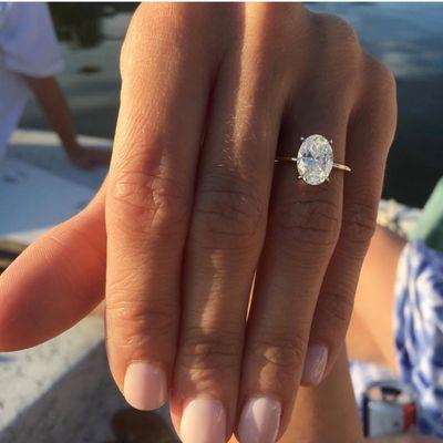 Stunning custom oval diamond engagement ring on a yellow gold shank.