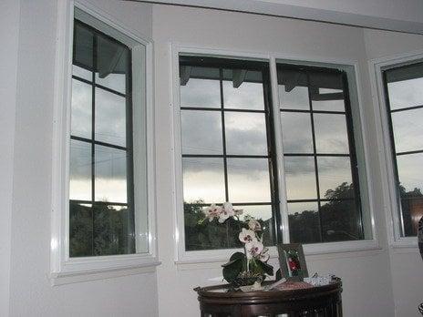 Surface mounted SPWT's installed over center 2-panel slider and 2 side single panel fixed pane windows.