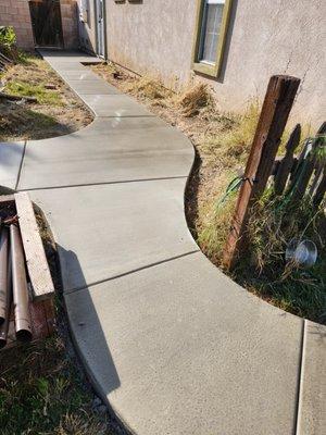 Sidewalk path from original patio through gate. 
 Love those curves.