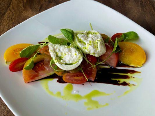 Heirloom Tomato & Burrata--

Assorted heirloom tomatoes, olive oil & basil emulsion, Maldon sea salt, aged balsamic vinegar