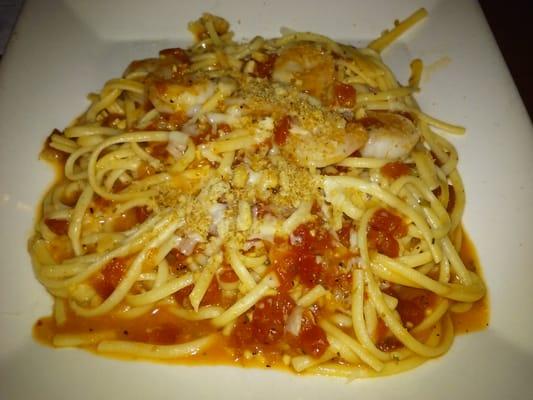 Shrimp Scampi Pasta - Shrimp sautéed in tomato and garlic sauce and tossed with linguini. Topped with parmesan and bread crumbs.