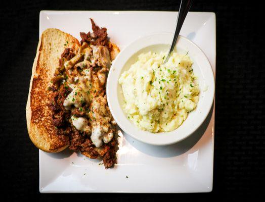 Mo-Town Philly Steak- Grilled, seasoned shredded Steak melted together with Peppers, Onions & Provolone Cheese. One side included.