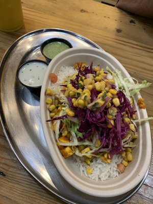 Bowl with paneer, white rice, beans, lettuce, pickled vegetables, corn masala