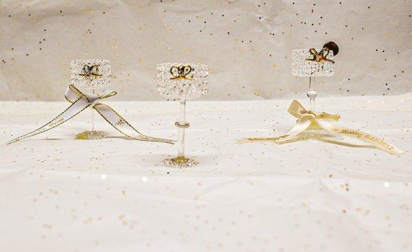 Miniature Crystal Glasses with a Gold Bow which may be used as party favors, along with personalized ribbons which we make to order.