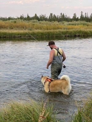 A boy and his dog fishing