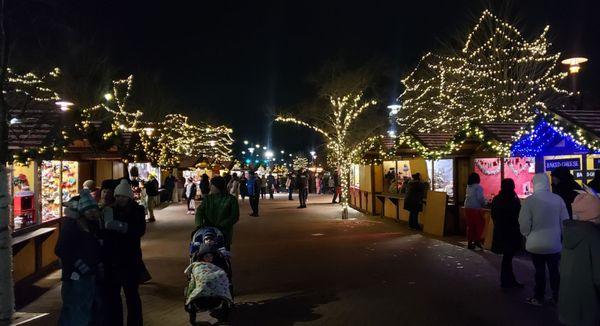 Gorgeous lights and booths on both sides with red & white striped roofs!