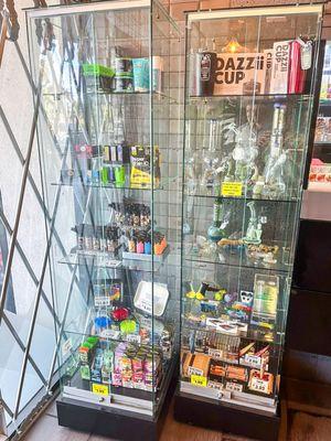 Display cases with glass pipes, torch lighters, grinders, rolling papers, and other smoke products