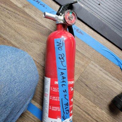 A fire extinguisher that has been used bur not replaced.