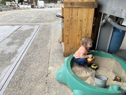 They have a little sand pit for kids to play in while you pay!