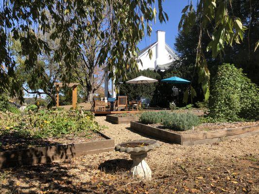 The deck is in the Boxwood Garden, surrounded by planters.