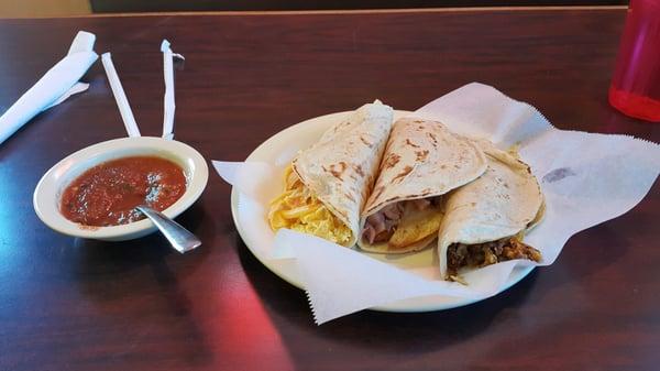 Migas, ham and potato, and egg and chorizo breakfast tacos.