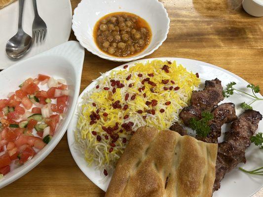 The #5 combo: 3 lamb kabobs-- partially hidden under the bread -- with rice, salad, and chickpea stew.