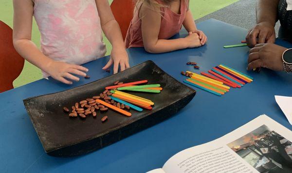 Math exploration using colorful sticks and beans!