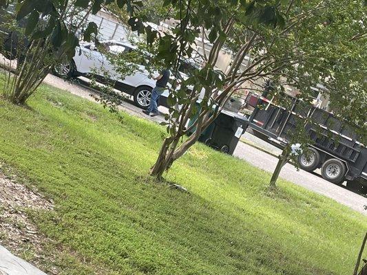 man checking trash can