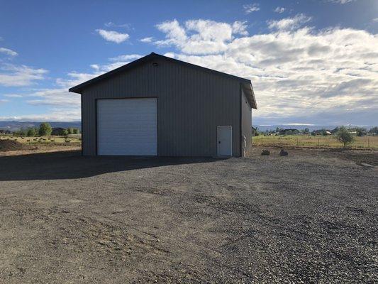 New shop located behind house use gravel driveway