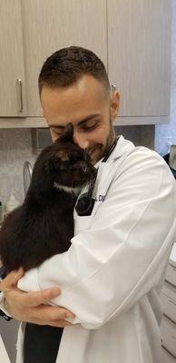 Dr. Torchia also loves cats! Getting cuddly with Tiny.