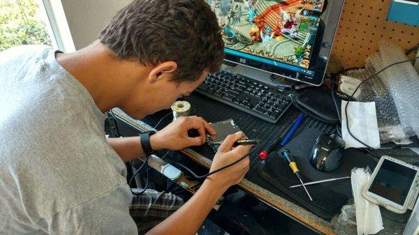 This is our electronics technician repairing a Samsung tablet power jack.