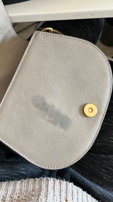 Oil stain left on my purse from the massage parlor. Owner has not responded to my request for reimbursement.