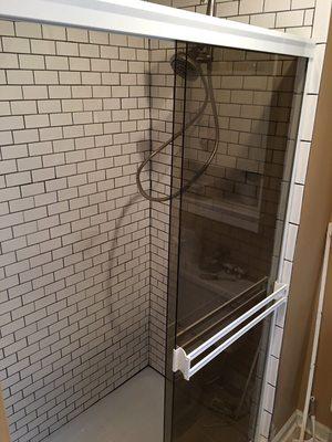 New shower pan, tile, and shower doors