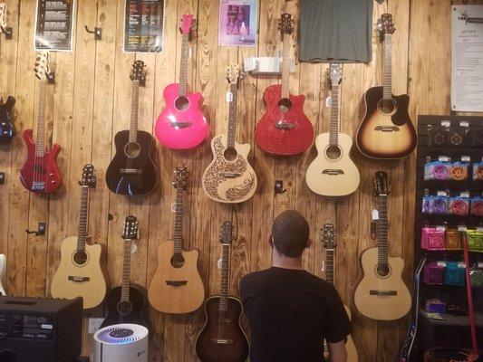 My son picking out his new guitar