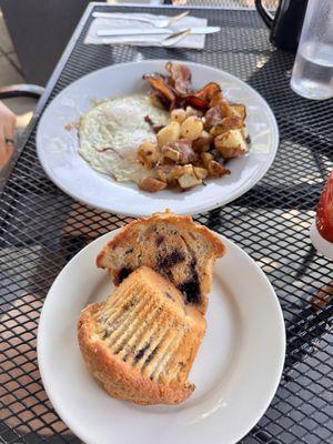 Blueberry muffin and eggs, bacon & potatoes.