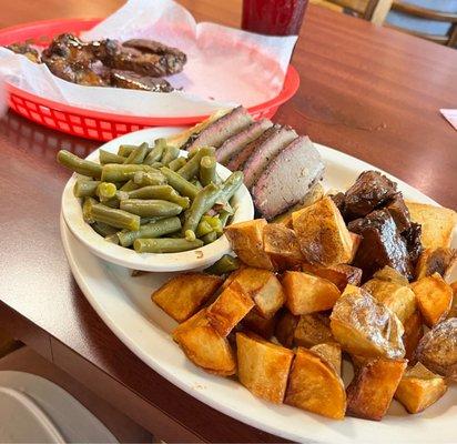 Smoked wings and two meat plate with green beans and home fries. Lots of food.