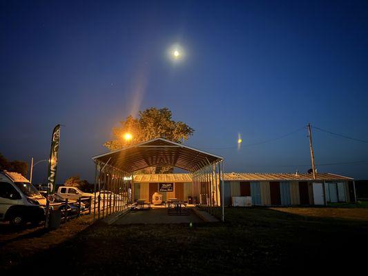 Covered outdoor seating area under the glow of the moon