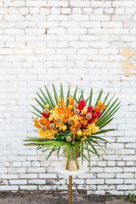 Inspired by the natural masterpiece of the sky, the Retro Sunrise comes arranged with a blend of vibrant red, orange, & yellow blooms