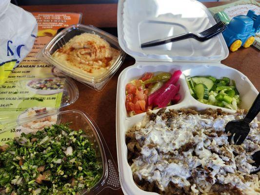 Lamb over rice with salad and pickles. Tabbouleh and hummus with pita.