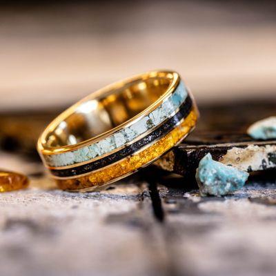 Custom gold wedding band with turquoise, meteorite and fossilized amber.