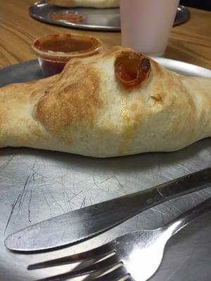 A pepperoni calzone with ricotta and mozzarella cheese fresh out of the oven.