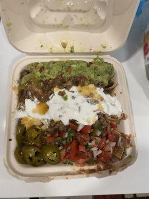 Super Steak Nachos with beans,cheese,meat,sour cream,salsa,jalapeños,guacamole etc etc