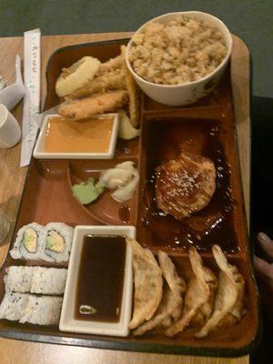 Salmon bento box with gyoza, California roll, veggie tempura, and fried rice!