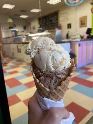 Banana pudding ice cream and mounds ice cream in a waffle cone