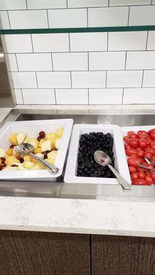 Fruit salad, blueberries, and tomatoes on breakfast buffet