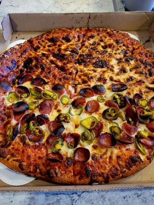 Large pizza with half cheese and half pepperoni and jalapeños