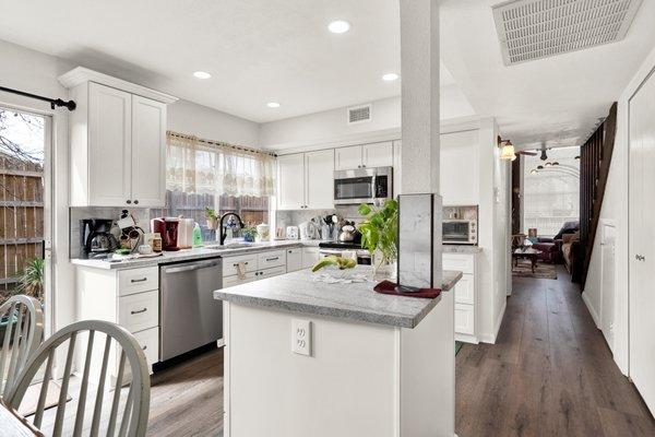 Kitchen redesign / remodel with all wood cabinets, pull outs, granite countertops, under mount sink, vinyl plank flooring and all new paint.