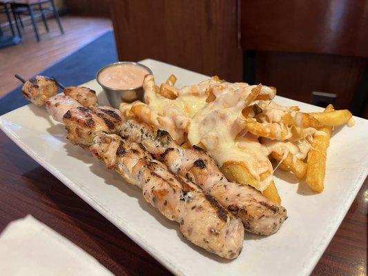 Chicken skewers and fries