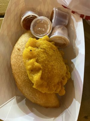 Beef yucca empanada and chicken pastel with a side of hot sauce and house sauce (ketchup and Mayo)