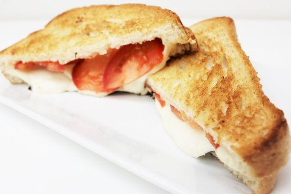 Tomato Basil Panini - Fresh sliced tomatoes, mozzarella and provolone cheese with basil, oregano, olive oil and red balsamic vinegar